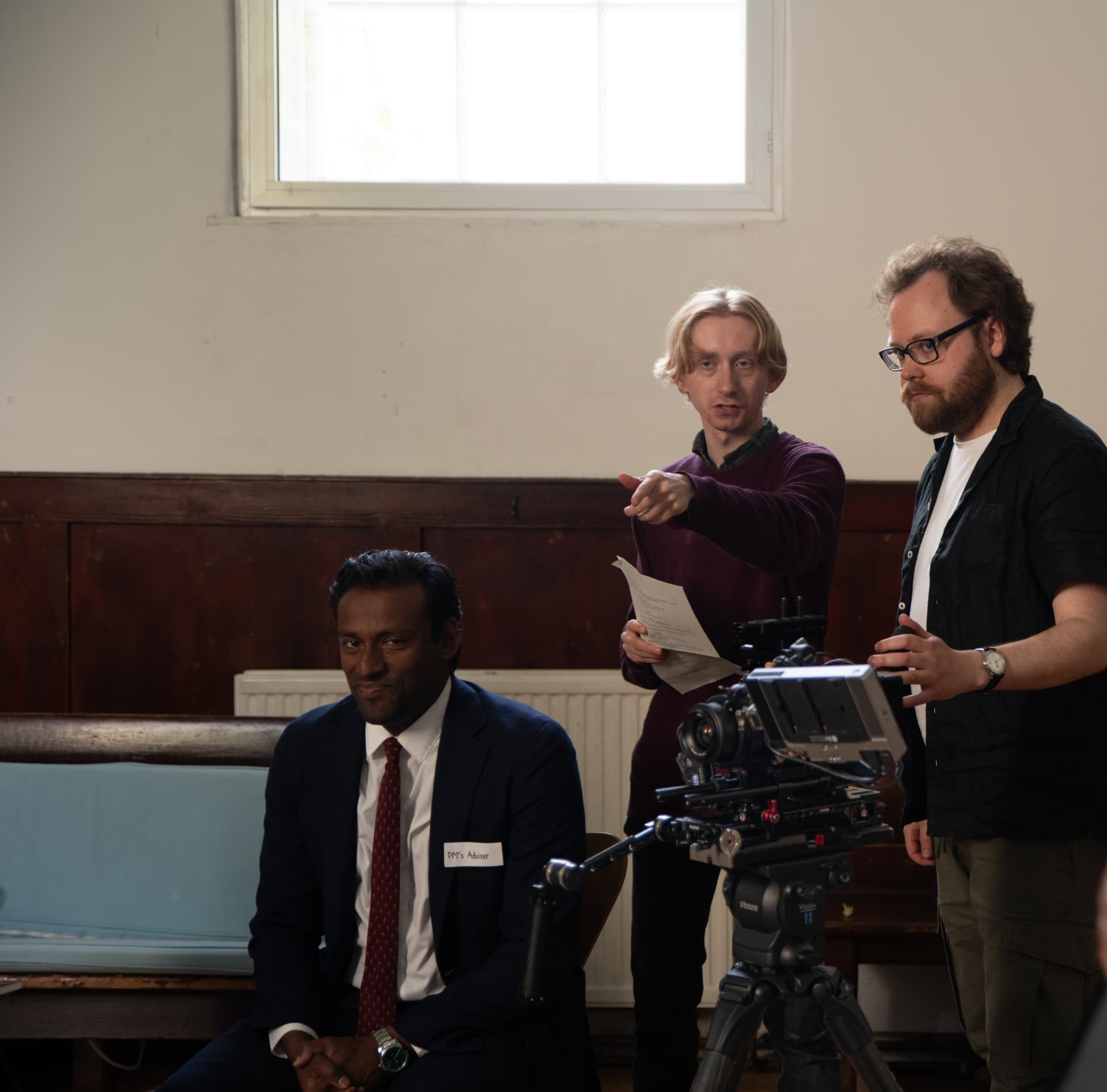 Peter Leon Brookes directing on set, script in hand, beside the camera