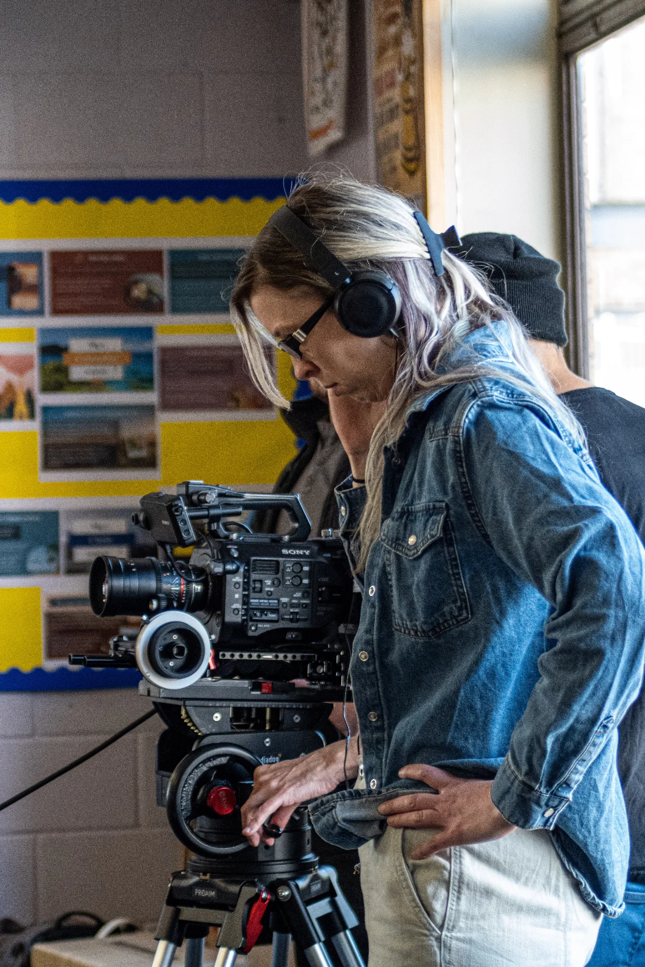 Kitty Harper behind a Sony camera with headphones